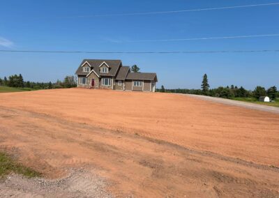 Newly cleared residential lot with home, showcasing prepared landscaping for future outdoor transformations by McIsaac Lawncare.