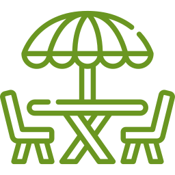 Outdoor dining table with umbrella and chairs, symbolizing inviting outdoor spaces for relaxation and entertaining, aligned with McIsaac Lawncare's landscaping services.